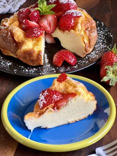 a piece of cheesecake with strawberries on top is sitting on a blue and yellow plate