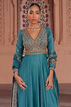 Turquoise fine silk padded tiered anarkali with attached can-can, Mughal jaal pattern yoke, contrast resham threads, zari, pot, sequin, cut dana, metal intricate embroidered yoke and sleeves. Paired with striped embroidered dupatta. - Aza Fashions Transitional Reception Anarkali Set With Dabka, Anarkali Choli With Dabka Detail In Chinon, Anarkali Choli With Dabka On Chinon, Anarkali Choli In Raw Silk With Dabka Detailing, Anarkali Silk Gown With Cutdana, Anarkali Silk Gown With Intricate Embroidery, Anarkali Lehenga With Dabka Detailing, Semi-stitched Silk Anarkali Set For Reception, Floor-length Silk Choli With Dabka Work