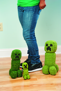 a person standing in front of three small stuffed animals on a wooden floor next to a wall