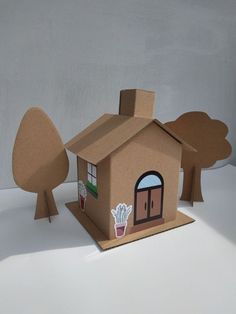 a cardboard house sitting on top of a white table