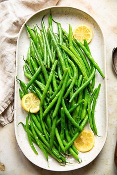 green beans and lemon slices on a plate