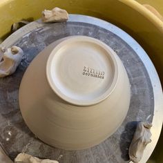 a white pottery bowl sitting on top of a table