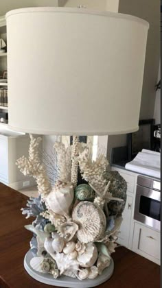 a lamp that is sitting on top of a table next to a book shelf and cabinets