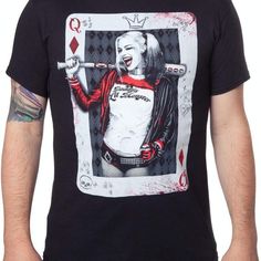 a man wearing a black t - shirt with a joker playing card on it