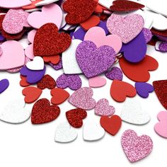 heart shaped confetti mix in pink, red and purple colors on a white background