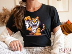 🐯💥Fierce Tiger T-Shirt - Unleash your inner strength with this bold and dynamic tiger design! This powerful and energetic illustration is perfect for those who love wild animals and want to make a statement. Ideal for casual wear or as a gift for tiger enthusiasts. Customized gifts are perfect for all family members and friends. Please review all photos before placing an order, ♥ HOW TO ORDER ♥ 🔍 Please review all the information provided before placing an order. - Select the Style \ Size and Energetic Illustration, Fierce Tiger, Cartoon Tiger, Tiger Shirt, Tiger Design, Tiger T Shirt, Un Logo, Inner Strength, Baby Size