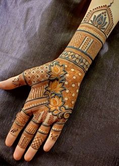 a woman's hand is decorated with hennap and intricate designs on it