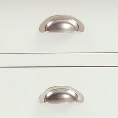 two white drawers with metal handles and knobs