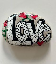 a rock with the word love painted on it