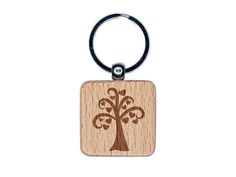 a wooden keychain with a tree on it