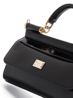 Sicily leather crossbody bag from DOLCE & GABBANA featuring black, leather, high-shine finish, logo plaque, single rounded top handle, detachable shoulder strap, gold-tone hardware and rectangle body. | Dolce & Gabbana Sicily leather crossbody bag Luxury Glossy Shoulder Bag For Business, Luxury Glossy Finish Business Shoulder Bag, Luxury Glossy Finish Shoulder Bag For Business, Elegant Bags With Glossy Finish And Double Handle, Luxury Shoulder Bag With Adjustable Handle, Elegant Double Handle Bags With Glossy Finish, Luxury Shoulder Bag With Glossy Finish And Double Handle, Evening Bags With Glossy Finish And Double Handle, Elegant Double Handle Shoulder Bag With Glossy Finish