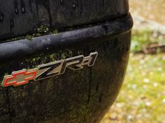 close up of the emblem on a black sports utility vehicle's rear bumper wheel