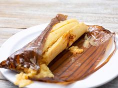 a piece of chocolate covered pastry on a white plate