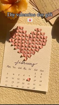 a calendar with hearts on it next to flowers