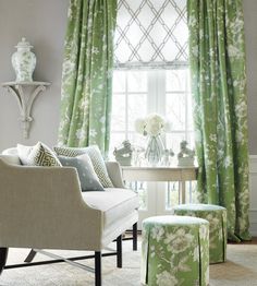 a living room filled with furniture and green curtains