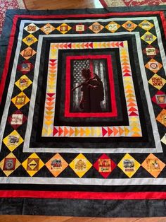 a black and red quilt on the floor with an image of darth vader