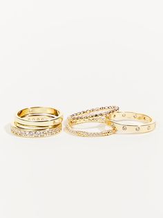 The set offers a variety of rings, allowing you to mix and match, stack them together, or wear them individually. The classic gold band design ensures a timeless look that transcends trends. However, the sparkling crystals add a touch of modern flair, keeping the rings relevant and stylish for any occasion. Jewlery Rings, Bracelet Pack, Wedding Branding, Altard State, Jewels Rings, Gold Ring Stack, Classic Gold, Shoes With Jeans, Sparkling Crystal