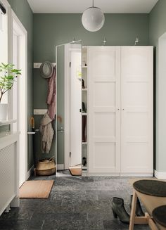 a room with white doors and grey flooring