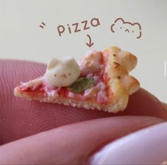 a tiny piece of pizza sitting on top of a persons finger with the word pizza written above it