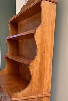 an old wooden book shelf with drawers