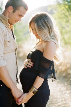 a pregnant couple standing next to each other