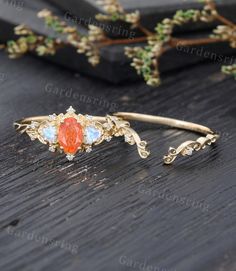 an orange and white stone sits on top of a wooden table next to some branches