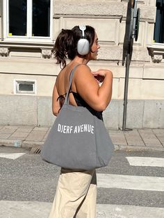 Our signature Tote Bag is made out of an organic cotton blend with our Djerf Avenue logo. It has a small inside pocket to fit your keys, phone or any other item you need close to hand. Every print is unique and due to the organic cotton, the intensity may vary. Everyday Gray Shoulder Bag With Phone Pocket, Gray Shoulder Bag With Mobile Phone Pocket For Everyday, Everyday Gray Shoulder Bag With Mobile Phone Holder, Eco-friendly Shoulder Bag With Cell Phone Pocket, Eco-friendly Shoulder Bag With Cell Phone Pocket For Everyday, Eco-friendly Canvas Pouch Bag For Everyday, Everyday Practical Shoulder Bag With Mobile Phone Pocket, Everyday Practical Shoulder Bag With Mobile Phone Holder, Eco-friendly Everyday Canvas Pouch Bag