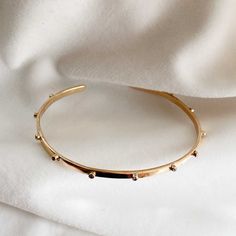 This simple solid gold cuff bracelet features 1.5mm lab grown brilliant cut diamonds all along the shaft. Feminine and minimal,  this solid gold cuff is classic yet modern - and as its made of solid gold it is perfect for everyday wear, yet unusual enough to make a delicate statement.  It would make a lovely gift for a special birthday or a modern way to celebrate an anniversary. This bracelet is made in your choice of solid  sterling silver 9k yellow, rose or white gold 14k yellow gold  18k rose, yellow or white gold.  PACKAGING AND GIFT WRAPPING  Every piece of Lily Flo Jewellery is wrapped up beautifully in our branded boxes and branded pouch ready to give or to receive as your special treat.  If you have ordered more than one piece, we will place it together in one box unless you've as Minimalist Yellow Gold Cuff Bracelets, Minimalist Gold-plated Yellow Gold Cuff Bracelet, Minimalist Yellow Gold-plated Cuff Bracelet, Minimalist Yellow Gold Plated Cuff Bracelet, Minimalist Tarnish Resistant Gold Plated Cuff Bracelet, Minimalist Everyday Gold Plated Cuff Bracelet, Minimalist Tarnish Resistant Cuff Bangle, Minimalist Tarnish-resistant Bangle Cuff Bracelet, Minimalist Tarnish-resistant Cuff Bangle