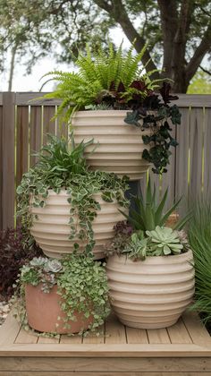 three large planters are stacked on top of each other