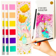 the unicorn legend coloring book is being held by a person's hand