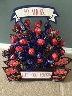 an arrangement of chocolate candies in a basket for someone's 50th birthday party