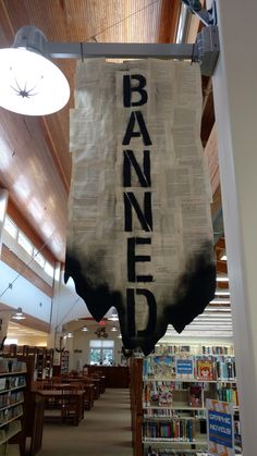 a banner hanging from the ceiling in a library