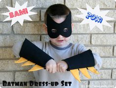 a young boy wearing a batman mask and gloves