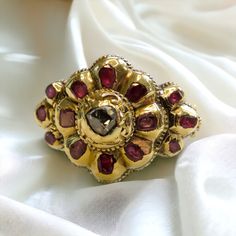 Georgian Era Iberian Ruby and Rose Cut Diamond Ring in 18-22K Gold What is Iberian jewelry? Iberian jewelry refers to jewelry that is inspired by or originates from the Iberian Peninsula, which includes Spain and Portugal.  It often incorporates elements of traditional Iberian culture, such as intricate designs, symbolic motifs, and the use of precious gemstones like rubies and diamonds. Iberian jewelry is renowned for its elegance, craftsmanship, and historical significance, reflecting the rich Baroque Yellow Gold Ceremonial Jewelry, Traditional Oval Jewelry With Historical Design, Ornate Baroque Jewelry With Rose Cut Diamonds, Baroque Rose Cut Diamond Jewelry For Wedding, Ceremonial Rose Cut Diamond Jewelry, Ceremonial Heirloom Ruby Ring With Intricate Design, Ornate Ceremonial Jewelry With Rose Cut Diamonds, Ornate Gold Ruby Ring, Ornate Rose Cut Diamond Jewelry For Ceremonial Occasions