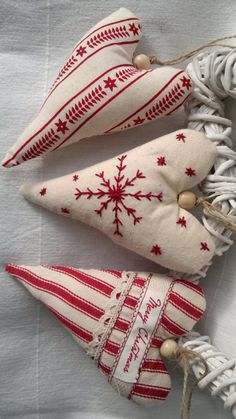 three red and white christmas ornaments on a table