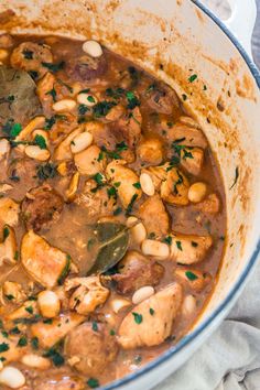 a pot filled with stew and beans on top of a table