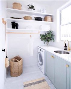 a washer and dryer in a small room with shelves above the washer