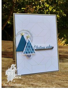 a handmade christmas card with a blue and white tree