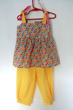 Handcrafted  - Flower Top - colorful -  & Pants - Yellow - for Girls 2 (two) YEARS Our clothes are full of little touches that will put a smile on your face whenever you or your child wears them.   We love using natural fabrics… …and believe that things should last.   They feel really comfortable for your child’s skin. HOT PRE WASHED FABRIC NO SHRINKING 100% COTTON MACHINE WASH WARM DO NOT BLEACH TUMBLE DRY LOW WARM IRON IF NEEDED   MADE IN USA Colorful Pants, Flower Top, Colored Pants, Flower Tops, Smile On, Natural Fabrics, Kids Wear, For Girls, Bleach