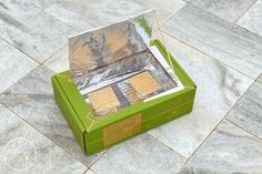 an open box on the ground with some food in it