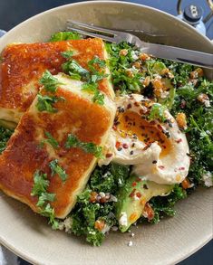 a white bowl filled with food on top of a table