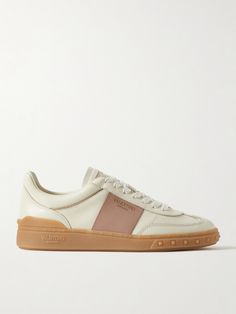 Valentino Garavani's sneakers come in a neutral ivory and blush colorway that'll go with so many outfits. Made in Italy from leather, they have lightly padded collars and rubber soles embossed with the label's moniker and iconic 'Rockstuds' in the same durable material. Valentino Garavani Sneakers, Valentino Garavani Shoes, Many Outfits, White Shoes Women, Latest Sneakers, Leather Silver, Metallic Leather, White Shoes, White Sneakers