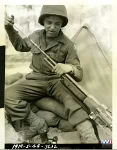 Official Signal Corps photograph of twenty-year-old Private Alton W. Knappenberger cleaning his automatic rifle. This photograph was taken in Italy on April 15th, 1944. Selected from The Terence J. Tully Collection 2002 at The National WWII Museum. Staff Sergeant, Medal Of Honor, Military History, The Twenties, Soldier