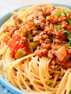 a blue bowl filled with spaghetti and meat