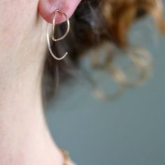 Inspired by the unfurling of a fern or a spring leaf, these nature inspired, swirling earrings are a nice halfway point between and dangle and a hoop design. Simple enough for work and everyday wear, but with enough sculptural whimsy to draw compliments, these earrings will soon be a favorite. Available in a smaller, more subtle size, as well as a larger, more eye grabbing size. Available in sterling silver, 14k gold fill, or mixed metal. All Rebecca Haas Jewelry is handcrafted by me in my South Everyday Spiral Earrings With Ear Wire, Minimalist Spiral Hand Forged Jewelry, Spiral Single Earring For Everyday Wear, Minimalist Spiral Jewelry With Matching Earrings, Dainty Spiral Jewelry For Everyday, Everyday Spiral Single Earring, Minimalist Spiral Earrings For Everyday Wear, Dainty Sterling Silver Wrap Earrings For Everyday, Minimalist Spiral Everyday Earrings