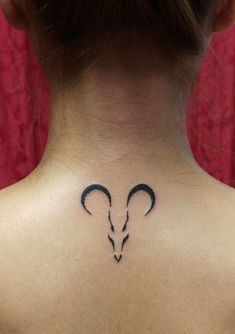 a woman with a goat head tattoo on her back