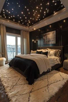 a large bed sitting in a bedroom next to a window with stars on the ceiling