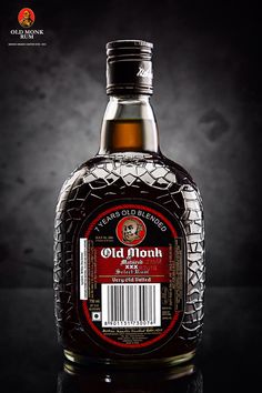 a bottle of old monk whiskey on a dark background with the label still in place