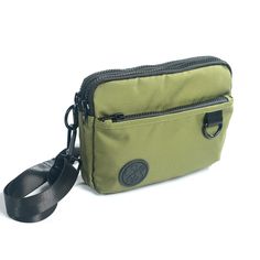 An earthy olive green with a silver gray liner. Versatile, fun and cute this lightweight bag features 3 functions in 1. Wear it as a hip pack, crossbody bag or wristlet. Stay hands free and carefree with plenty of room for your wallet, keys, phone and other small everyday necessities. Our strap system is intended to create versatility of use and fit a variety of body types. Includes:-4 zippered compartments -52” strap that fits waist/hip size 39”-61.5” or extend fully for crossbody wear -31” str Trendy Green Belt Bag For Everyday, Green Zipper Pouch For On-the-go, Casual Green Belt Bag For Everyday Use, Casual Green Belt Bag, Green Belt Bag With Adjustable Strap, Green Belt Bag With Adjustable Strap For Everyday, Trendy Green Belt Bag With Phone Pocket, Multifunctional Green Shoulder Bag For Daily Use, Trendy Green Belt Bag With Mobile Phone Holder