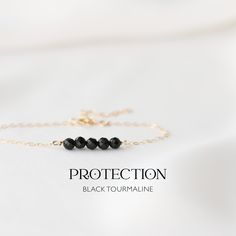 "Delicate protection bracelet - handmade with Black Tourmaline 4mm Crystal Beads on a 14k Gold-Filled or 925 Sterling Silver chain. Our black tourmaline bracelet is your daily source of strength and confidence. It serves as a potent shield against negativity, ensuring you move through life's emotional energies with unwavering resilience. Wear it every day and feel empowered, knowing you have a steadfast companion to boost your confidence, provide strength, and offer protection from any negativit Minimalist 14k Gold Filled Bracelets With Gemstones, Hand-strung Minimalist 14k Gold-filled Bracelet, Minimalist Hand-strung 14k Gold Filled Bracelet, Minimalist Gemstone Beads Bracelets As Gift, Minimalist Gemstone Beaded Bracelets As Gift, Minimalist Gemstone Beads Bracelet As Gift, Minimalist Gemstone Beaded Bracelet For Gifts, Minimalist Gemstone Beaded Bracelet As Gift, Minimalist Beaded Bracelet With Gemstone Beads As Gift